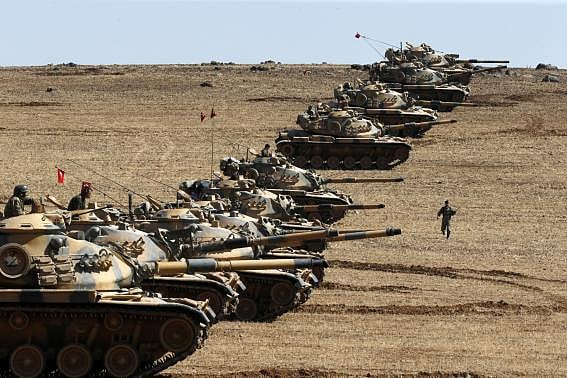 Turkish army tanks take up position on the Turkish-Syrian border near the southeastern town of Suruc in Sanliurfa province 